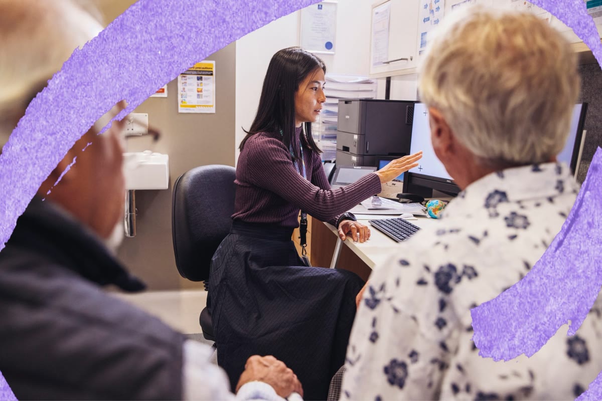 A practice nurse at a desk with a patient
